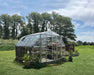 Canopia Americana 12' x 12' Greenhouse_Silver_placed in grassfields