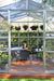 Canopia Americana 12' x 12' Greenhouse with woman reading inside