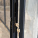 Close-up image showing the lock and keys of the Canopia SanRemo Patio Enclosure, with a focus on the door's gray frame and handle.