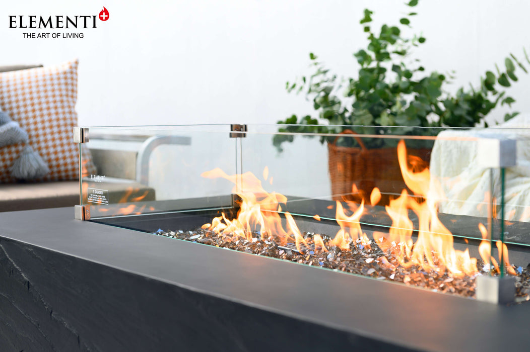 A stylish Elementi Cape Town Fire Table with vibrant flames, elegantly placed on a cozy patio setting