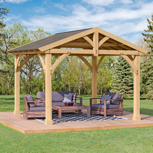 Fully assembled Yardistry 11x13 Pavilion with Aluminum Roof in a garden setting with outdoor furniture under its shelter.