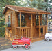 Cozy Cabin Playhouse & Sandbox 7x9 with toys outside