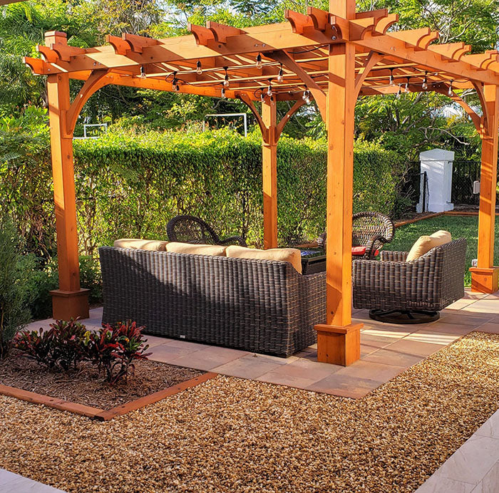 Outdoor Living Today Pergola with Retractable Canopy 12x12 on a leveled tiled flooring with outdoor seating in a backyard setting