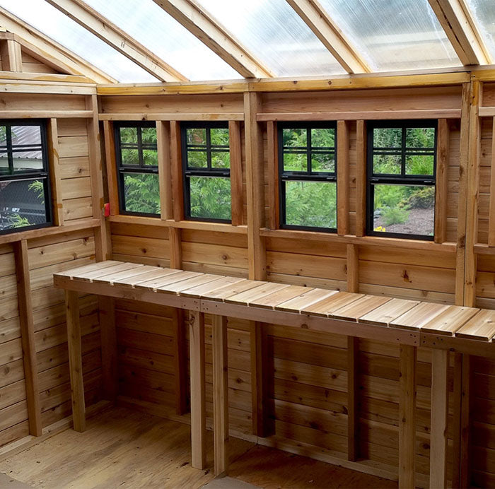 The interior of the OLT Sunshed Garden Shed showing its shelf, windows and a clear roof