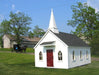 A quaint Little Cottage Chapel Playhouse with a white steeple and red doors, nestled in a green pastoral setting with a clear blue sky overhead.