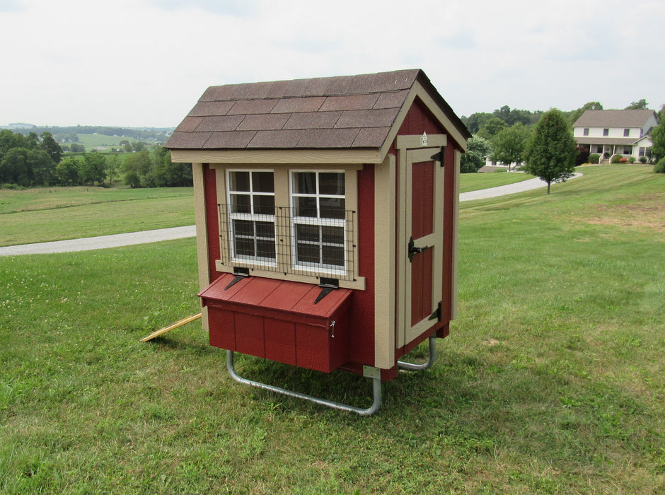 EZ-Fit 4x6 chicken coop kit with window guards, situated in a green field.