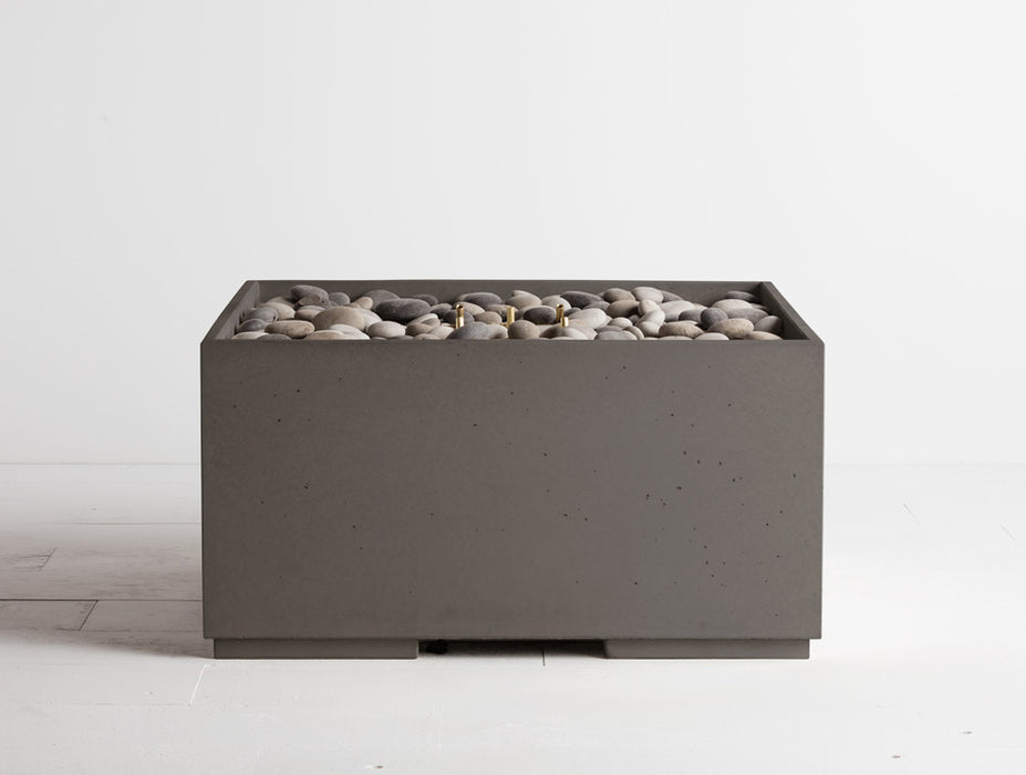 Cinder grey Solus Decor Firebox 30 featuring a minimalist cubic structure filled with natural pebbles for an elegant outdoor ambience.