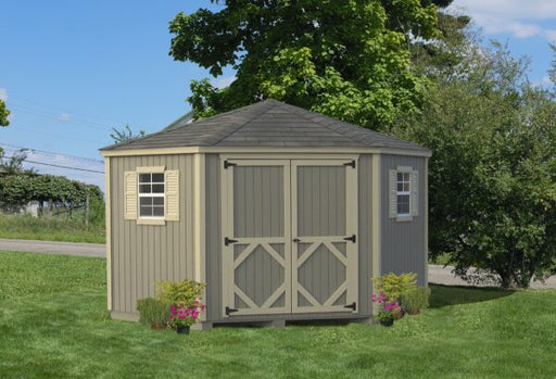 A neatly designed Classic Five Corner Shed by Little Cottage Company with cream and grey colors, adorned with flower boxes under the window.