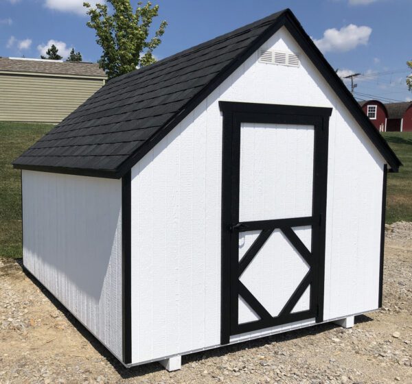 The classic exterior of a Little Cottage Company Playhouse in Cape Cod style, with white and black accents, showcased against a clear sky.