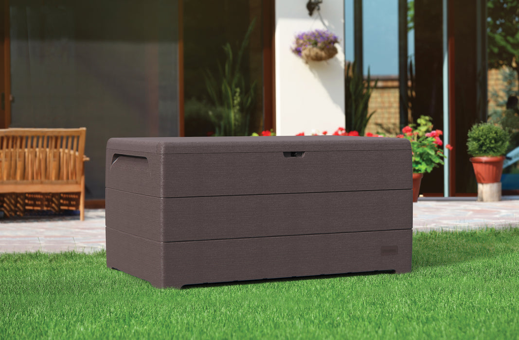 The Duramax 416 Liter/110 Gallon Outdoor Rectangle Box, closed, featuring a sleek brown textured finish, placed outdoors on a green lawn with a wooden bench and potted plants in the background.