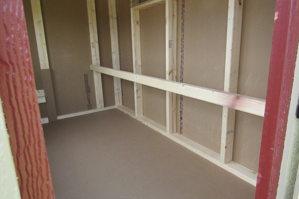 Interior view of EZ-Fit's 5x8 chicken coop showing the sturdy wood construction and spacious design for poultry.