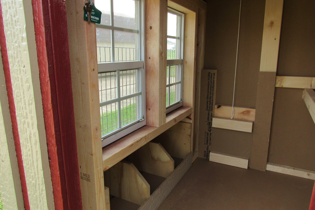 Inside perspective of the EZ-Fit Sheds Chicken Coop, showing the light-filling windows and the nesting area for chickens.