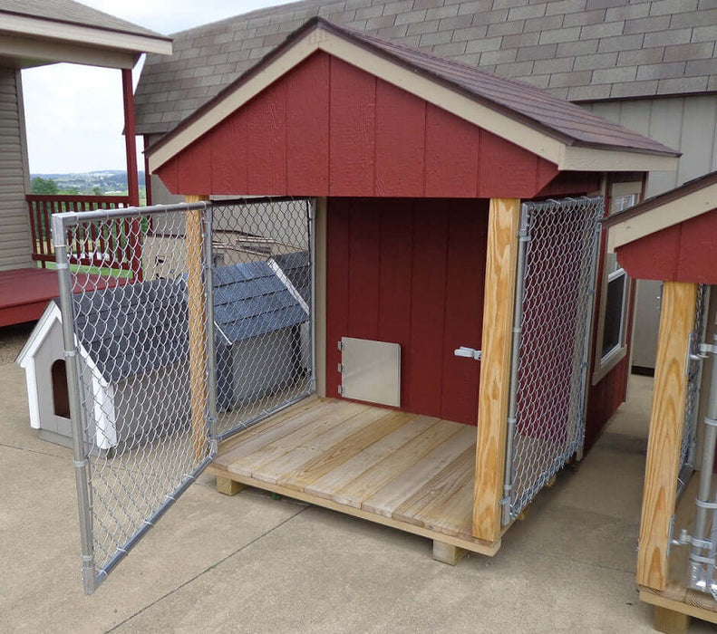 Spacious EZ-Fit kennel in red, providing a sheltered area and an attached run for dogs, placed next to a home.