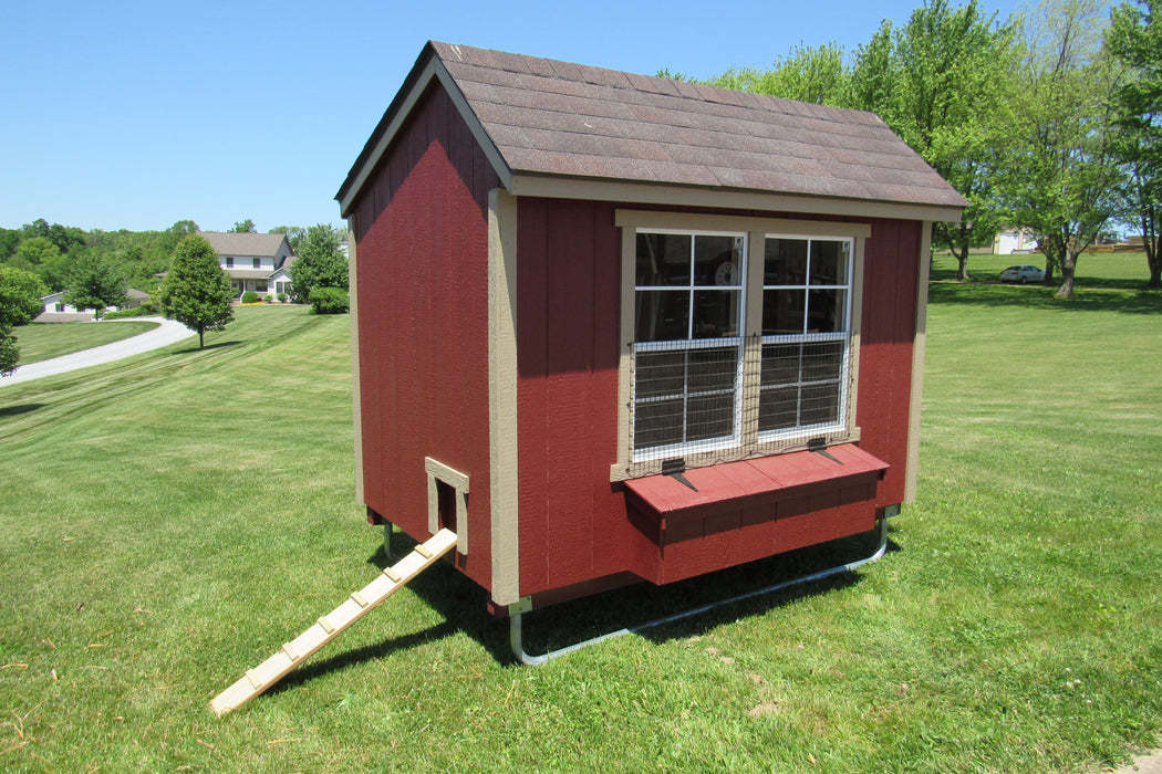 A spacious 5x8 red chicken coop by EZ-Fit, set in a lush green backyard, with a side ramp and windowed exterior.