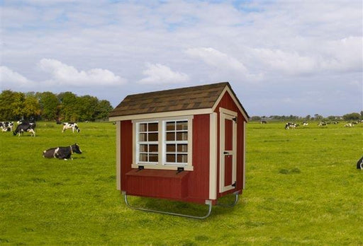 Portable chicken coop in red by EZ-Fit set against a pastoral background with cows.