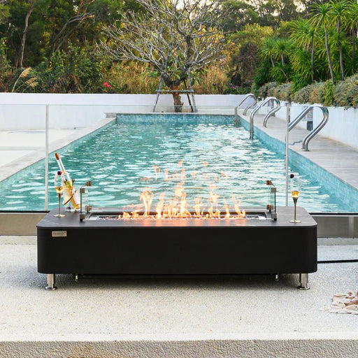 Valencia Rectangular Marble Fire Table beside a pool