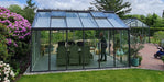 Prominent display of a glass greenhouse with a black frame.