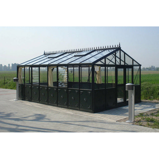 The Exaco Janssens Retro Royal Victorian VI Greenhouse stands elegantly in an open field, its classic design highlighted against the expansive horizon.