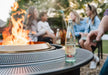 Close up shot of the Solo Stove Fire Pit Surround with bottles on top.