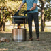 Man holding Solo Stove Pi Fire in outdoors.