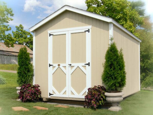 A serene view of the Classic Gable Shed by Little Cottage Company, with a beige finish, white trim, and surrounding greenery.