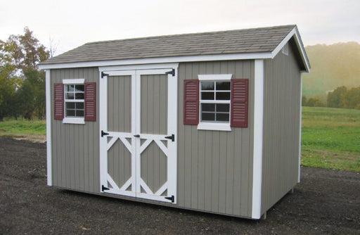 Side view of a grey Classic Garden Workshop Shed with white double doors and contrasting shutters, presented in a rural outdoor setting.