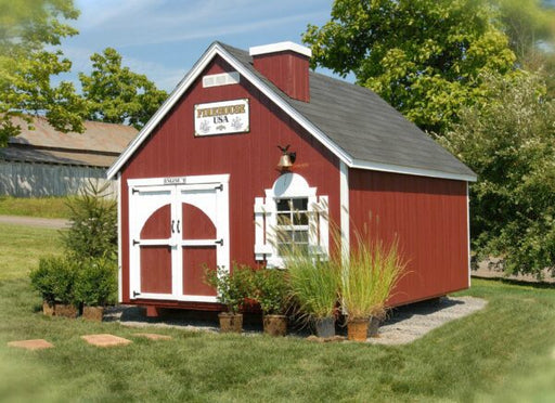 The Firehouse Playhouse by Little Cottage Company in a charming garden setting