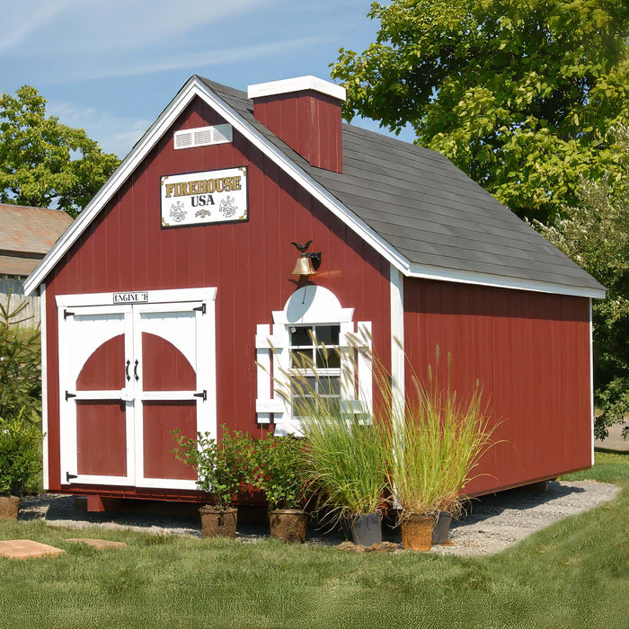 The Firehouse Playhouse by Little Cottage Company in a charming garden setting
