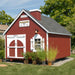 The Firehouse Playhouse by Little Cottage Company in a charming garden setting