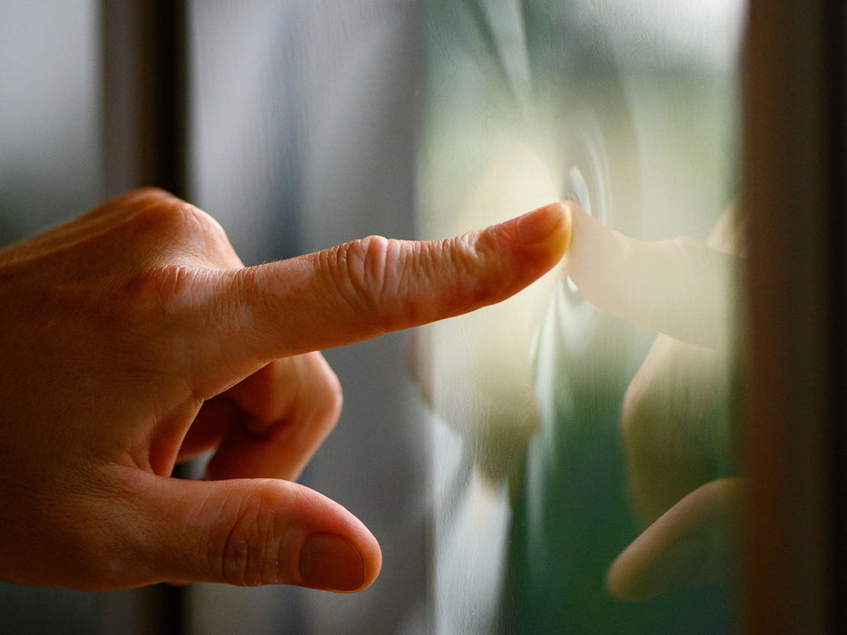 Close-up of a finger pressing against the clear polycarbonate window of the Gazebo Penguin Florence, demonstrating the material's flexibility and durability.