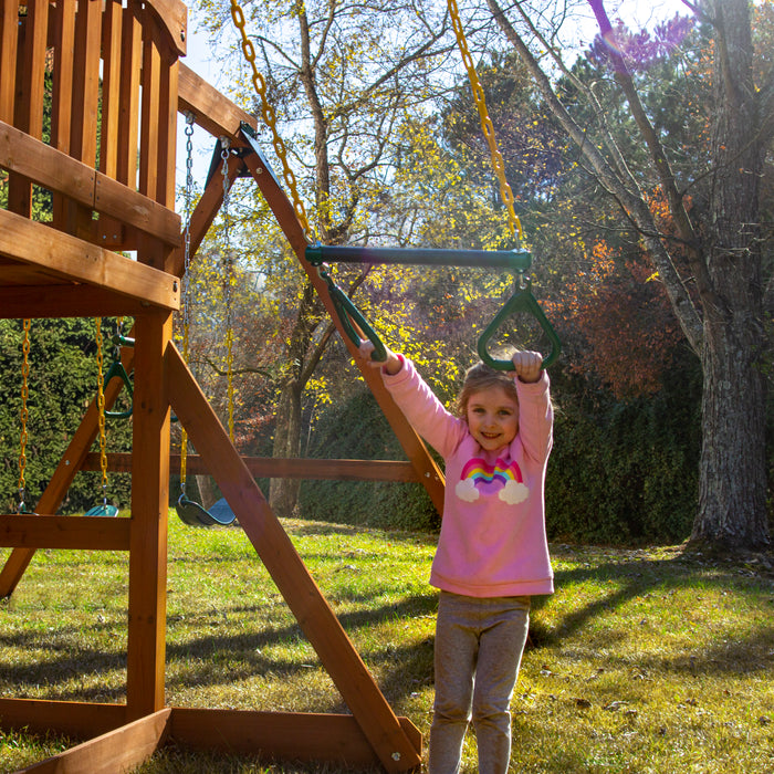 A child on a Trapeze play of the Gorilla Playsets Outing With Trapeze Bar Swing Set
