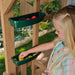 A girl playing on the hideaway clubhouse playset