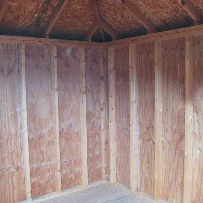 The interior of the Classic Five Corner Shed showing natural wooden walls and a peaked roof, providing a spacious and sturdy structure.