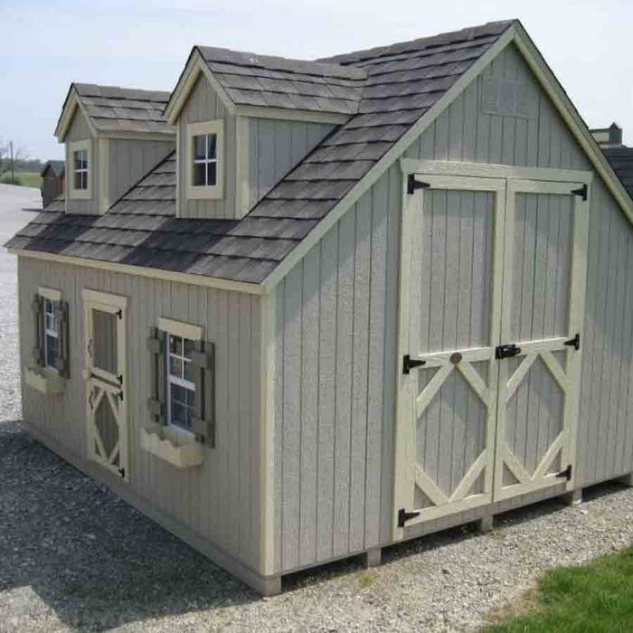 Inside view of the Little Cottage Company's Cape Cod Playhouse, featuring wooden walls, a play table, and chair set for kids.