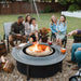 Family around a Large Solo Stove Fire Pit Surround barbecuing marshmallows.