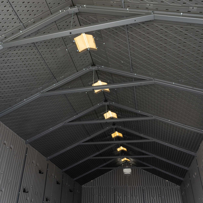Interior view of the Lifetime 8 x 17.5 ft Outdoor Storage Shed's ceiling, featuring skylights and steel trusses.