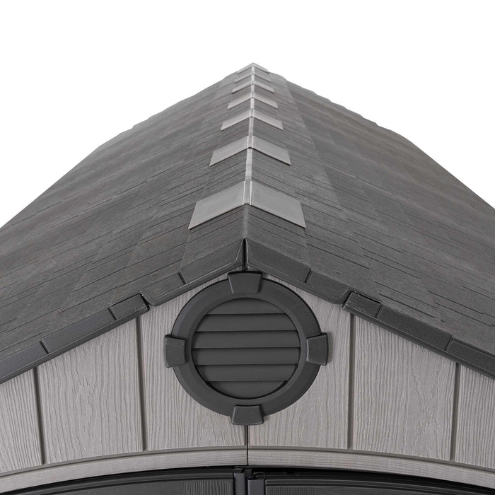 Detailed view of the peak of the Lifetime 8 x 17.5 ft Outdoor Storage Shed's roof, showing the vent and shingle texture.