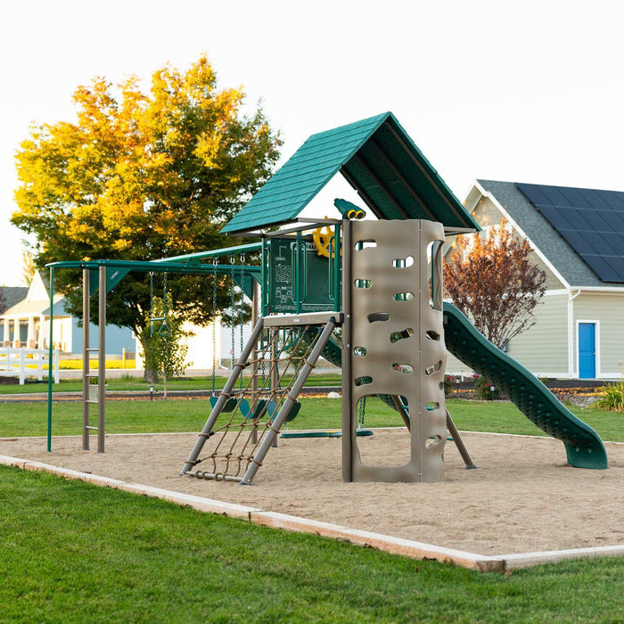 Full view of the Lifetime 91080 Playset installed in an outdoor park setting at dusk.