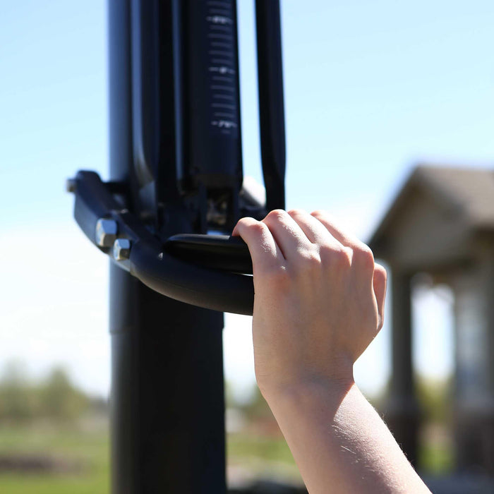 Close-up view of a person's hand adjusting the height of a Lifetime Portable Basketball Hoop.