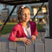 Child leaning on the railing of the Lifetime Adventure Clubhouse Playset, with sunlight on her face.