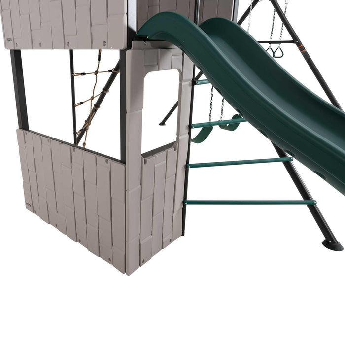Detailed view of the slide and adjacent rope climbing net on the Lifetime Adventure Clubhouse Playset.
