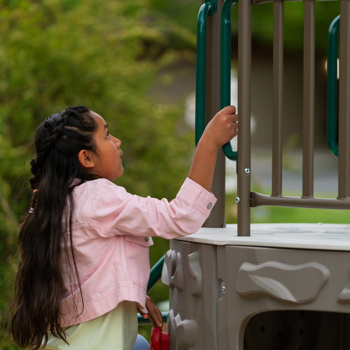 A child climbing the stairs of the Lifetime Adventure Slide Tower playset.