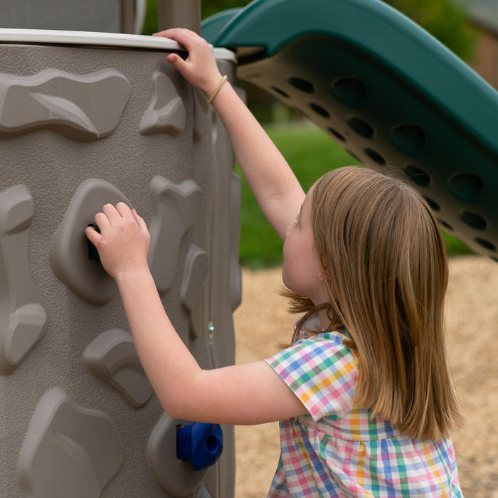 Close-up of a child's hand gripping a climbing hold on the Lifetime Adventure Slide Tower.