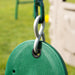 Close-up of the green swing and its chain links attached to the playset.