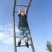 Boy hanging from the monkey bars on the Lifetime Adventure Tower Deluxe playset.