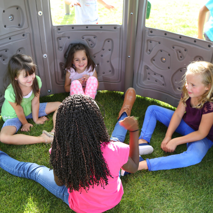 Children sitting inside the lower compartment of the Lifetime Adventure Tower Deluxe playset.