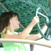 Girl holding the steering wheel at the top of the Lifetime Adventure Tower Deluxe playset.