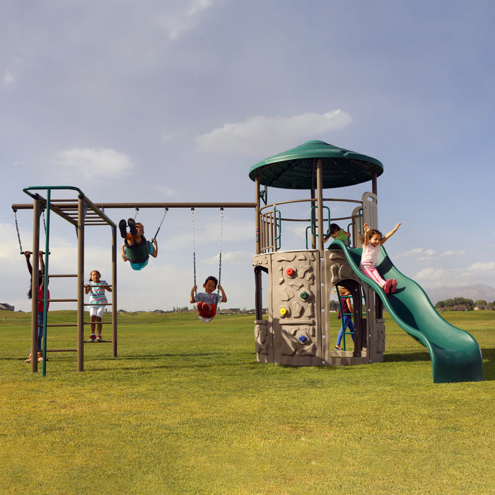 Full view of Lifetime Adventure Tower Deluxe with multiple children playing on swings and climbing wall.