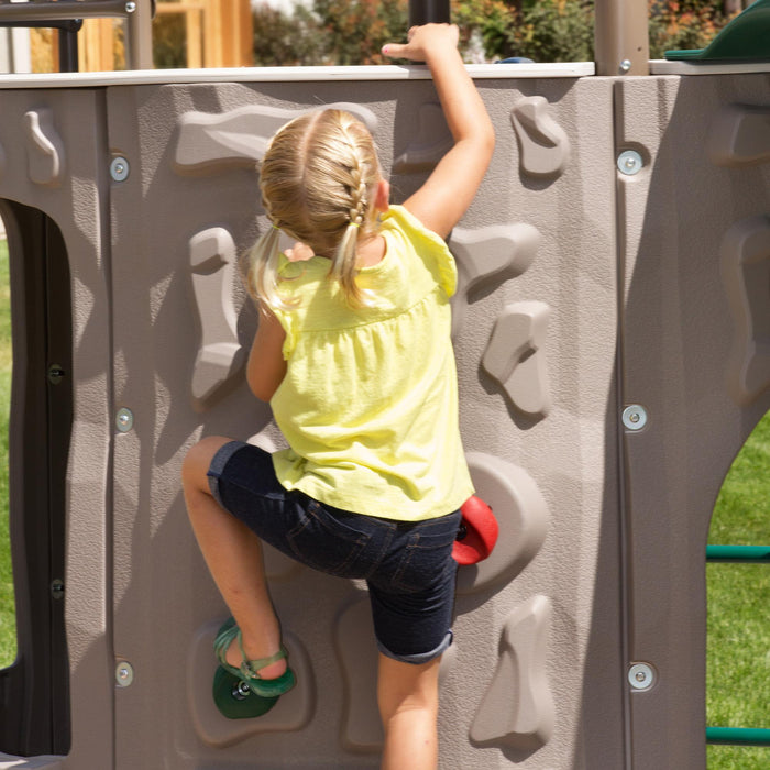 Child climbing the rock wall of the Lifetime Adventure Tower Playset, SKU 91200.