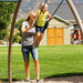 Child swinging with the help of an adult at the Lifetime Adventure Tower Playset, SKU 91200.